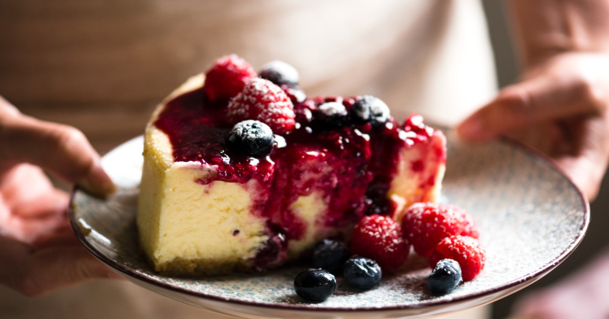 tempting cheesecake-topped with berries and syrup