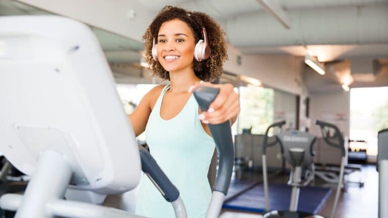 girl working out on elliptical with adjustable stride