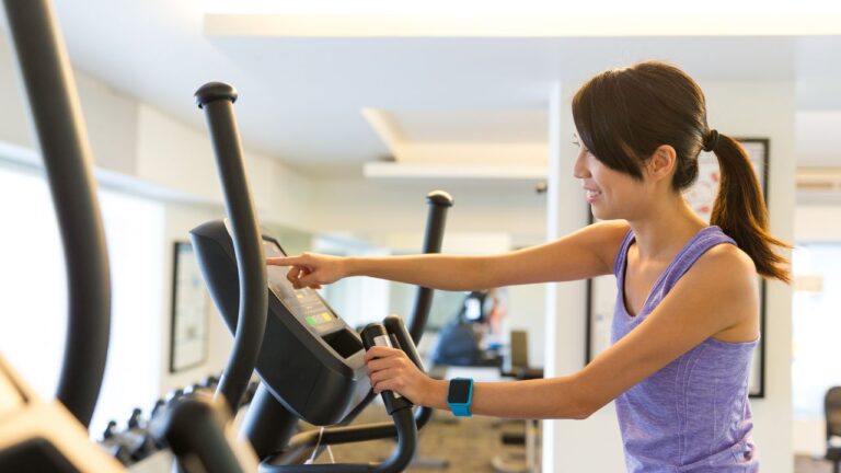 A lady workout on an elliptical for low ceilings